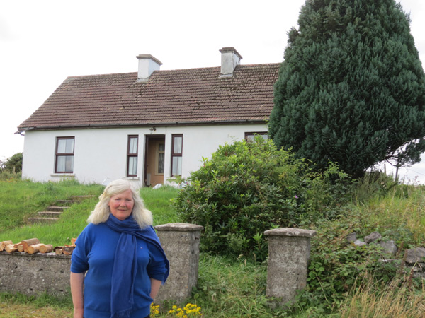 The author's cousin Fidelma Burke on the site where the Burke family grew up in the townland of Ballydotia, Moycullen Co Galway